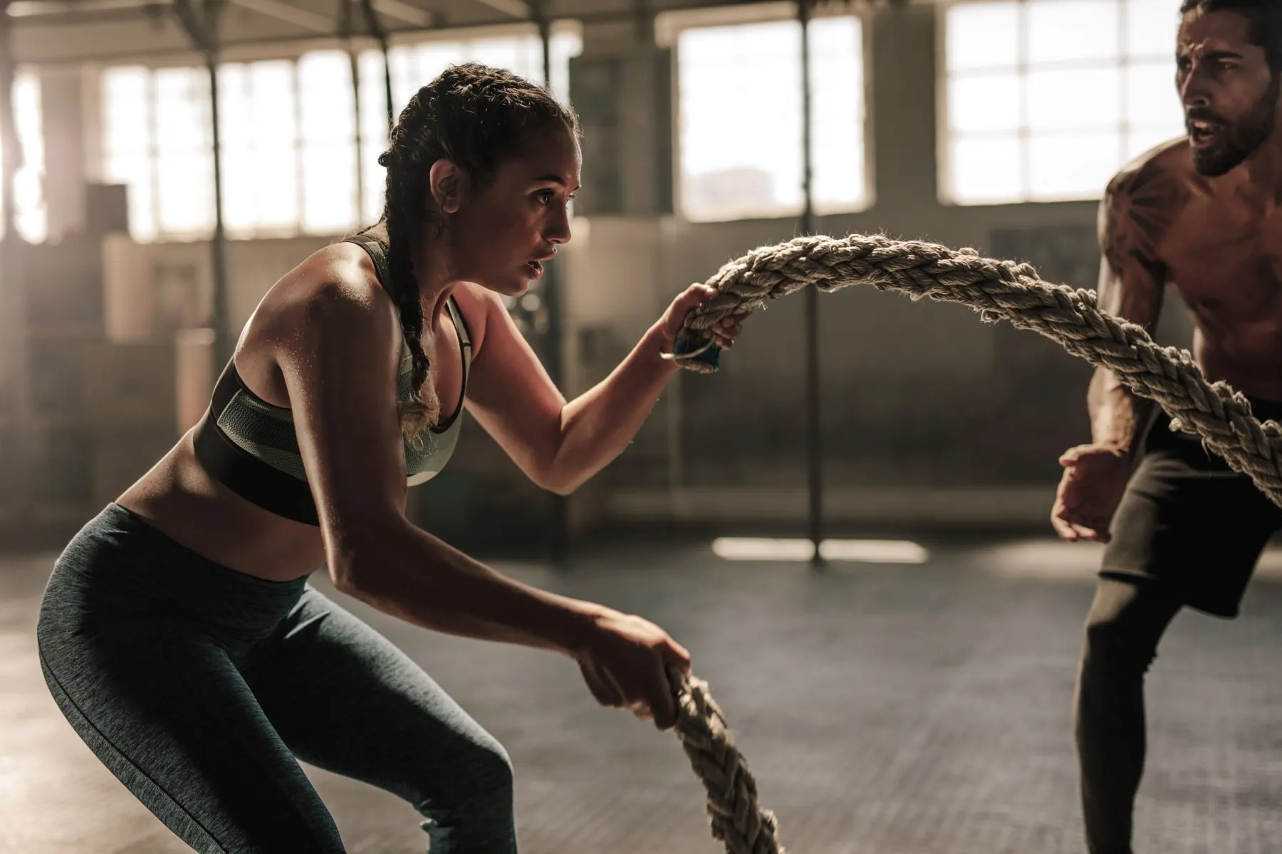Athlete training with battle ropes